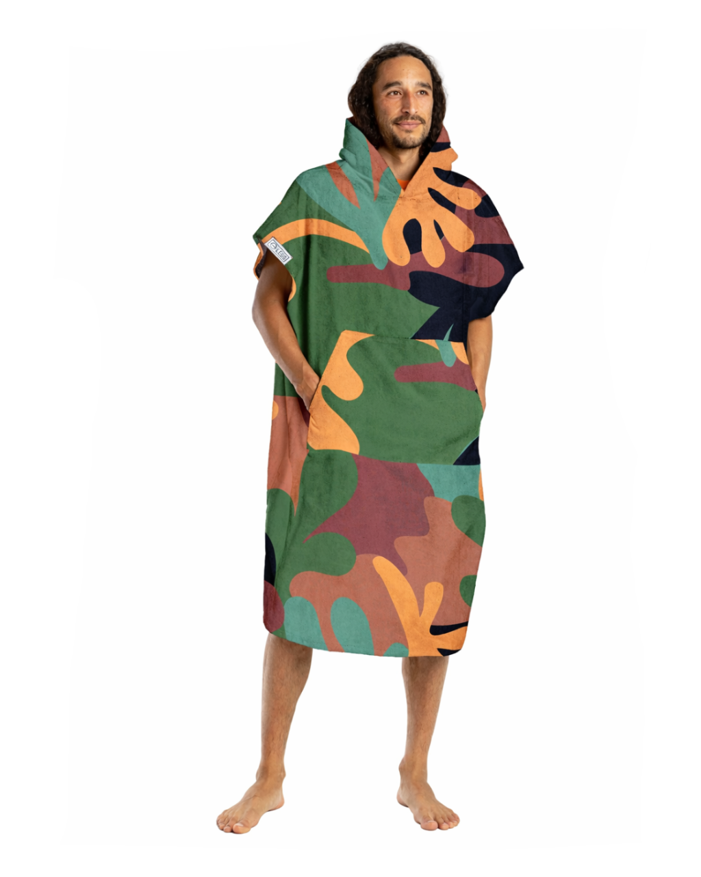 Person wearing a colorful hooded towel with abstract patterns on a white background