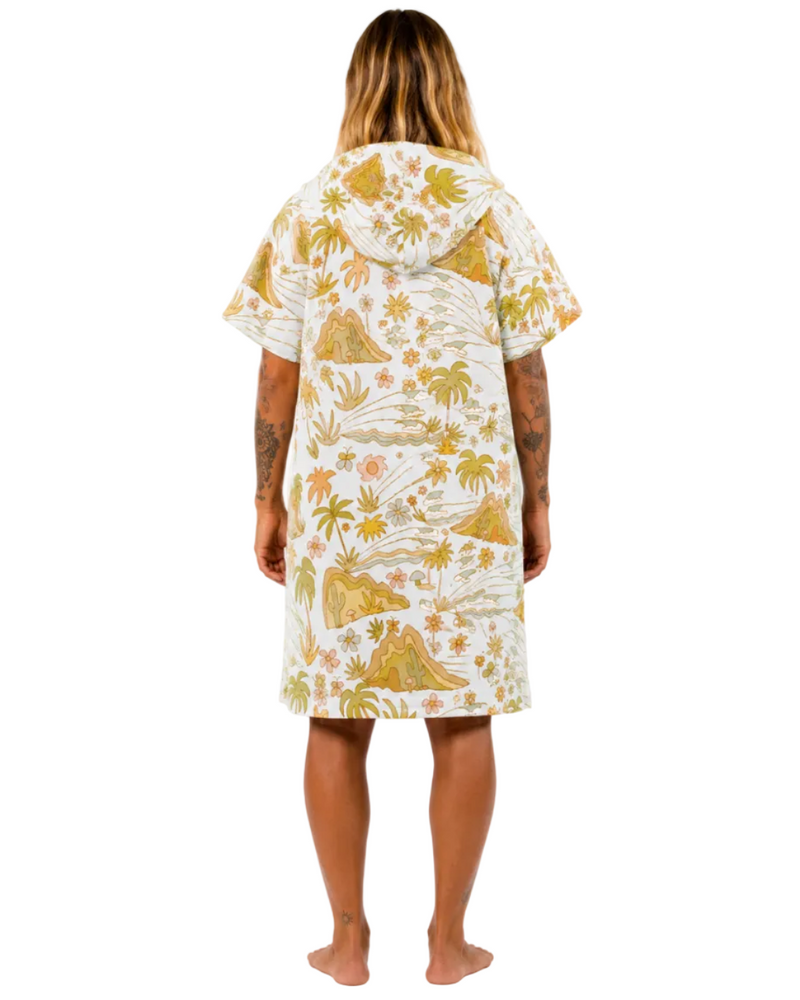 Woman wearing a tropical patterned dress on a white background