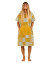 Woman wearing a yellow patchwork dress on a white background