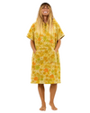 Woman wearing a yellow floral dress on a white background