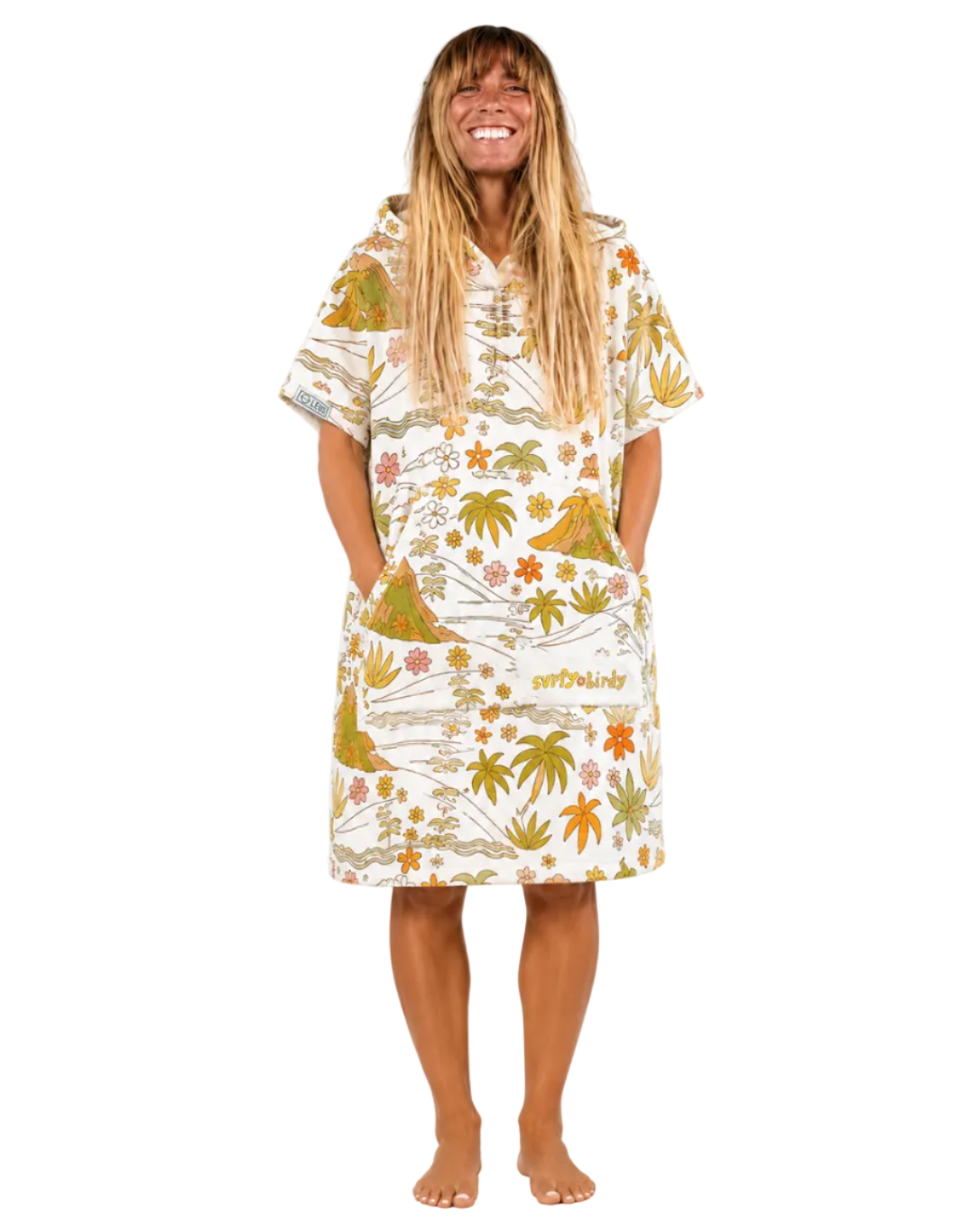 Woman wearing a tropical patterned dress on a white background