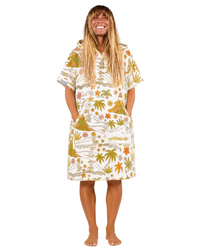 Woman wearing a tropical patterned dress on a white background