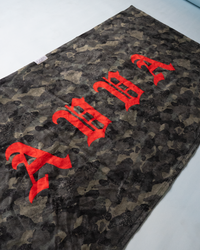 Close-up of AVVA x LEUS beach towel showing premium fabric texture, bold surf-inspired pattern, and high-quality woven label detail