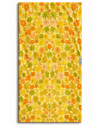 Floral patterned towel with a brand logo on a yellow background