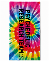 A rectangular beach towel featuring a vibrant rainbow tie-dye spiral pattern with bold black vertical text reading 'PSYCHEDELIC RESEARCH TEAM' on the front.