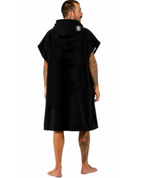 Man wearing a black hooded towel with a logo on the back